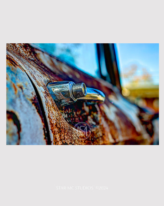 Close-up of a patina-covered vintage GMC truck door, captured in limited edition fine art photography—textured, moody wall art printed on ChromaLuxe metal or Museum Quality Fine Art Paper.