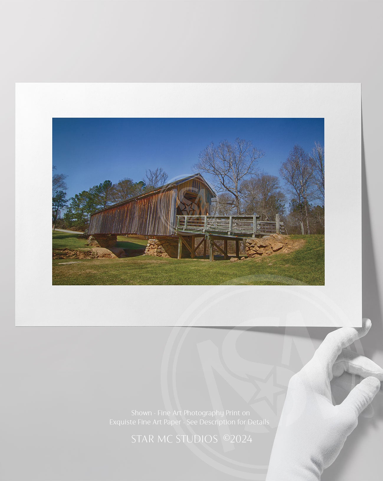 Historic Auchumpkee Creek covered bridge spanning a serene wooded creek, captured in limited edition Southern fine art photography for art collectors.