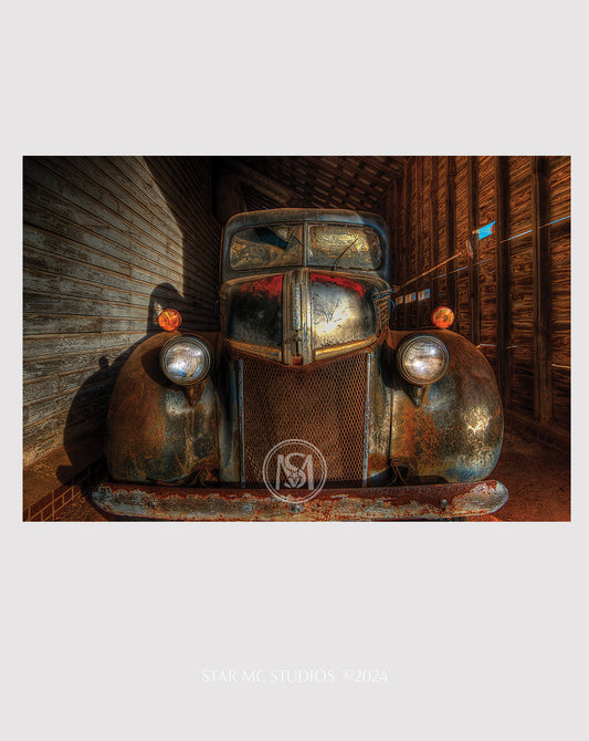 Vintage 1941 Ford F-100 truck illuminated by golden twilight inside an old corn shed, captured in limited edition Southern fine art photography.