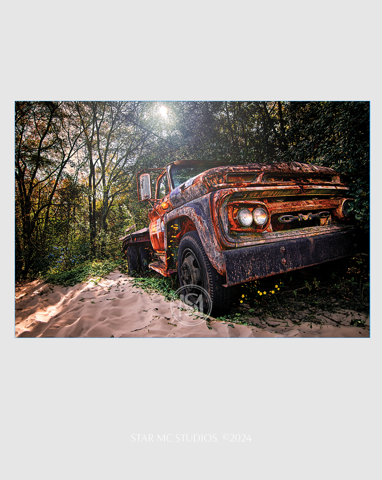 Abandoned GMC truck surrounded by coastal sands and weathered by time, captured in limited edition Southern fine art photography—moody and reflective.